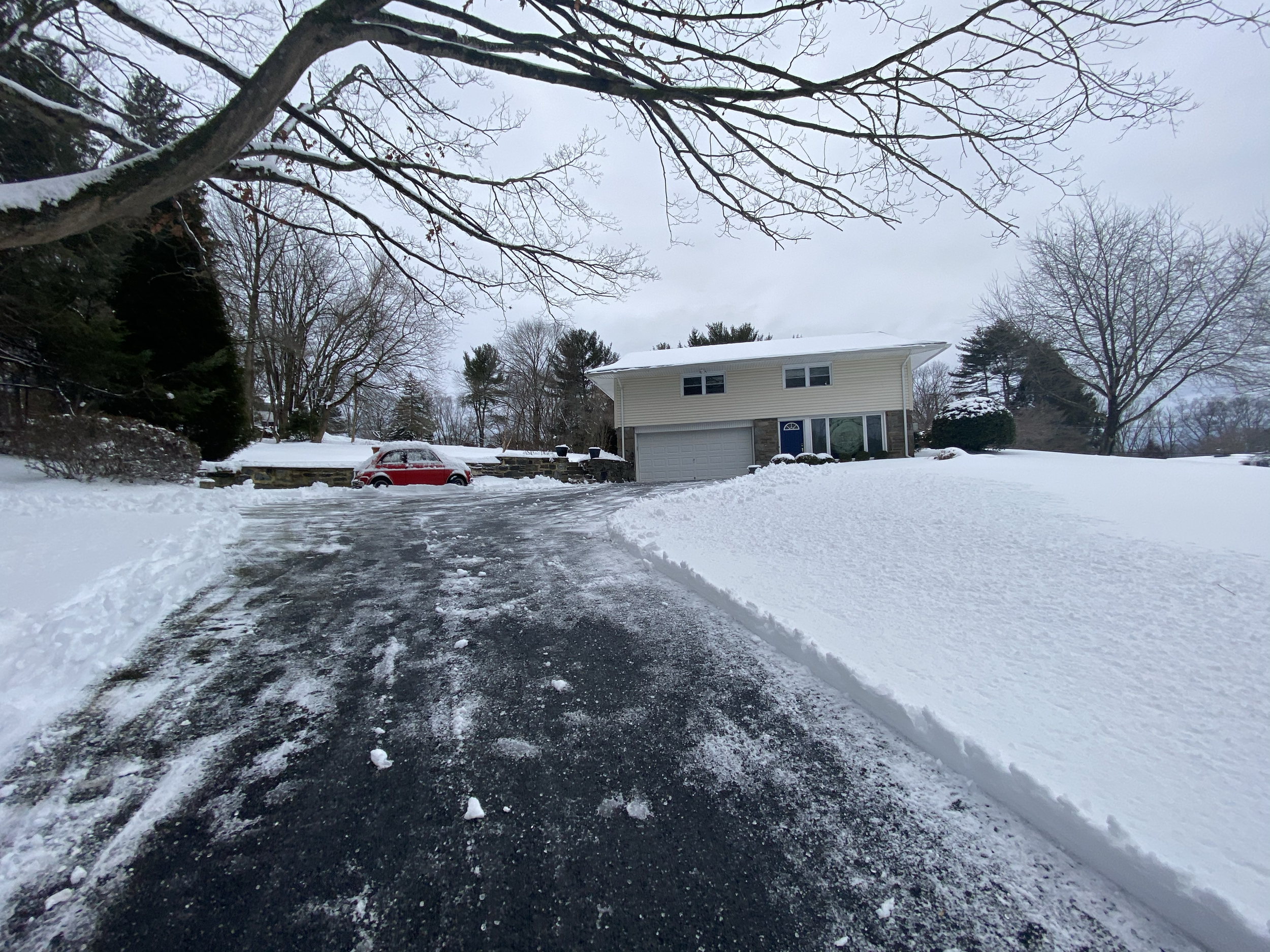 Snow-cleared residential driveway following winter snowfall, highlighting professional driveway plowing and snow management services that help maintain safe, accessible entrances.
