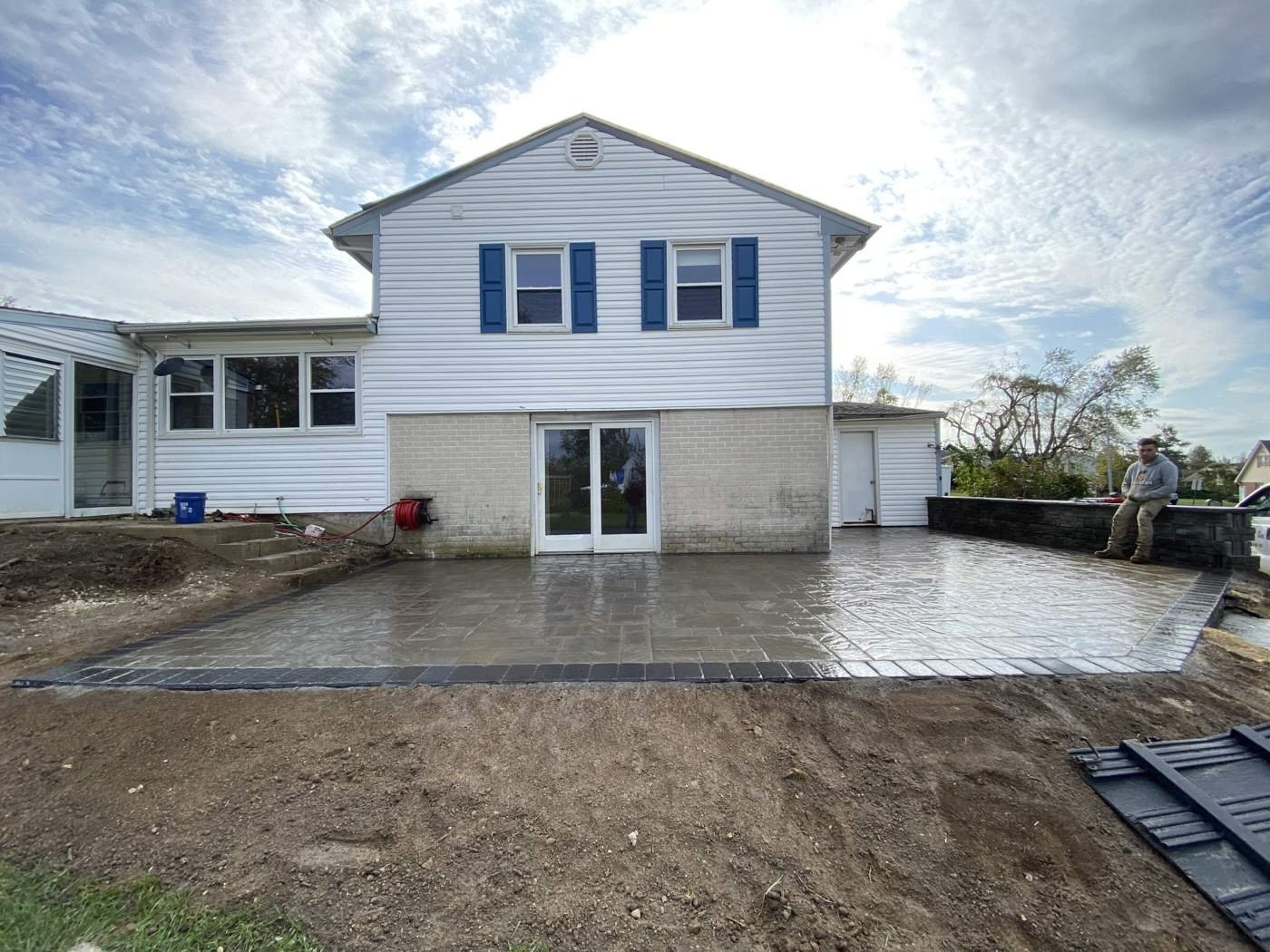 Residential paver patio installation with a custom outdoor living area. View our paver patio services.