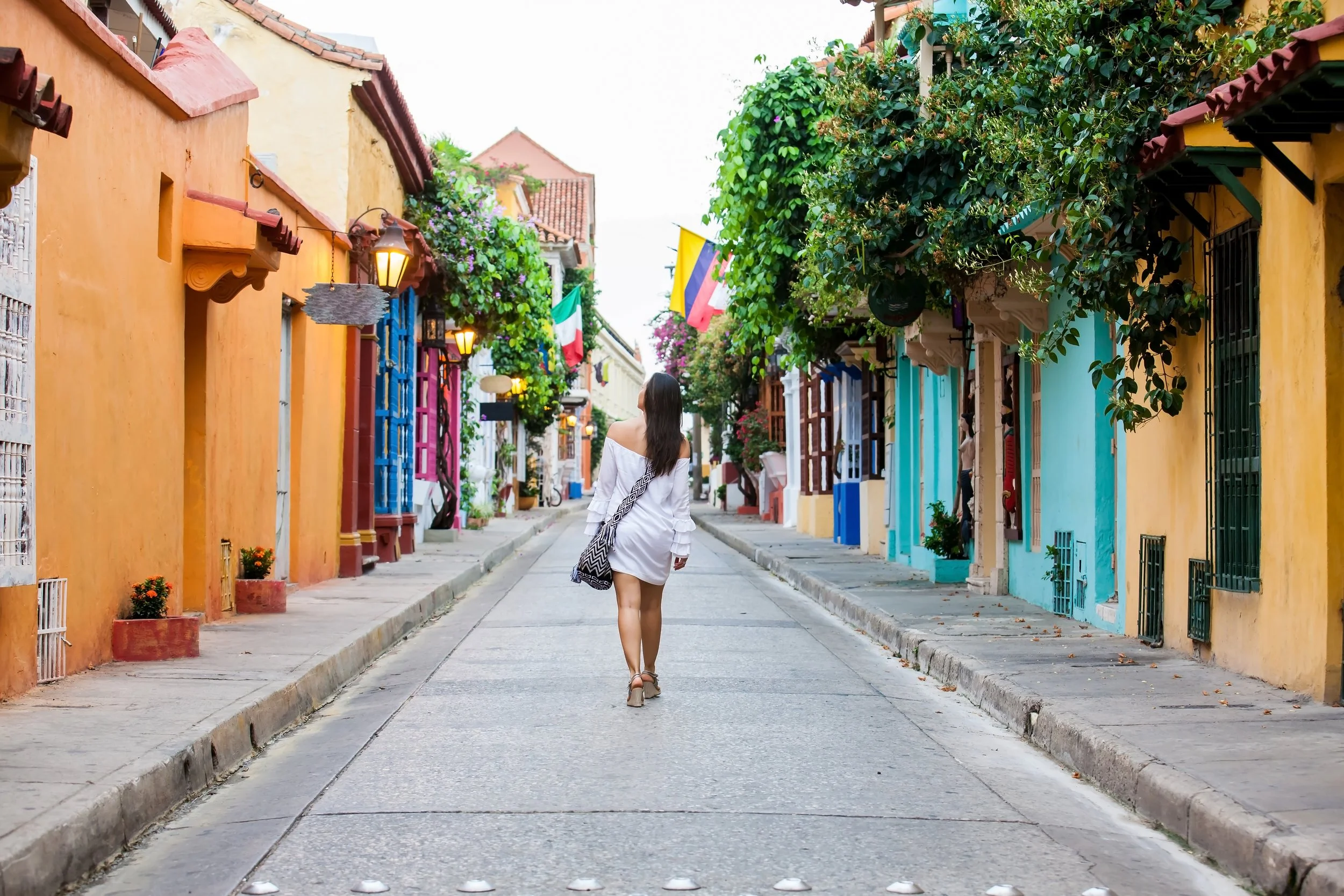 vecteezy_beautiful-woman-on-white-dress-walking-alone-at-the-colorful_23803764.jpg