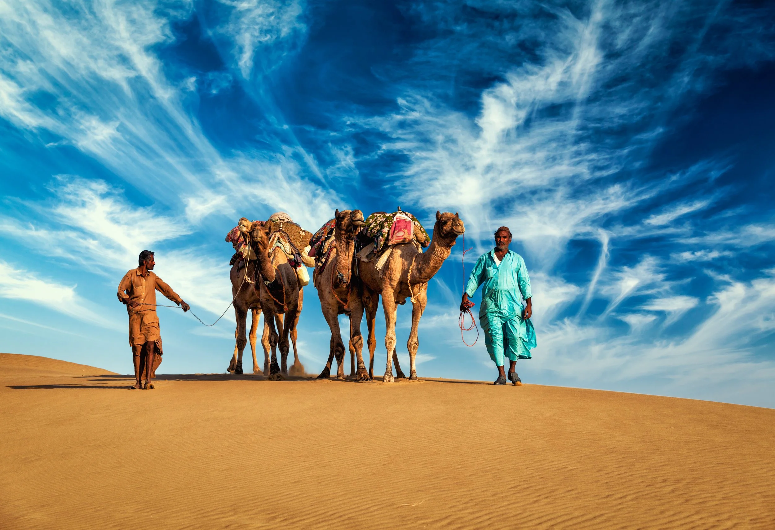 vecteezy_two-cameleers-camel-drivers-with-camels-in-dunes-of-thar-desert_40943115.jpg