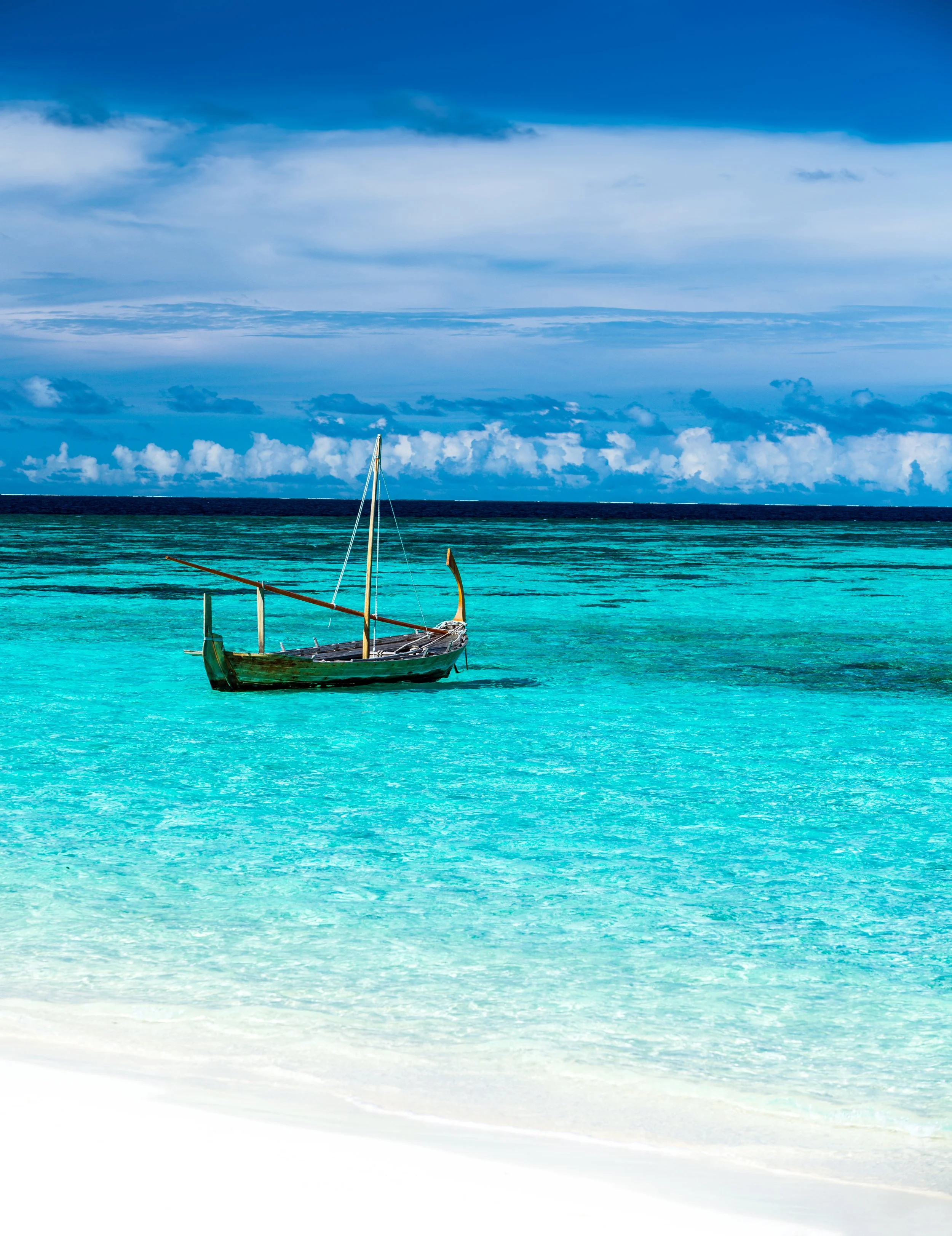vecteezy_little-fishing-boat-in-blue-sea_36448986.jpg