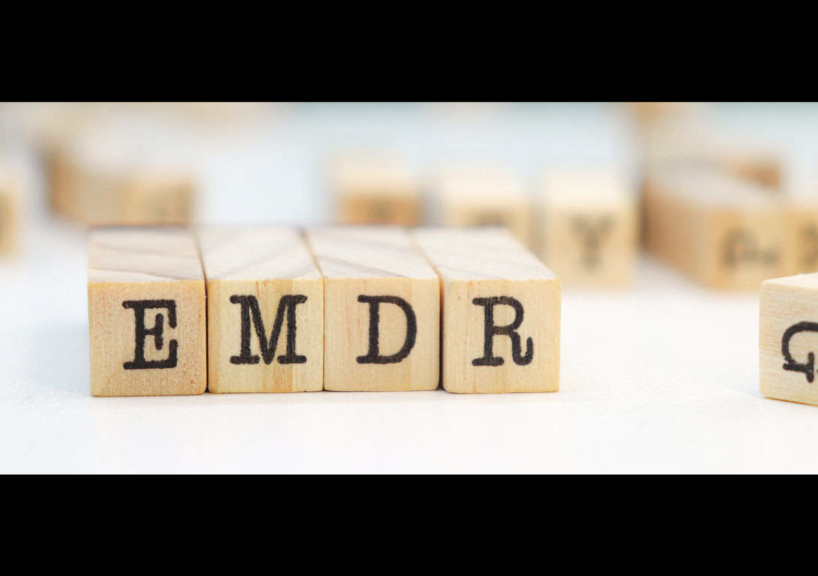 Wooden letter tiles spelling EMDR