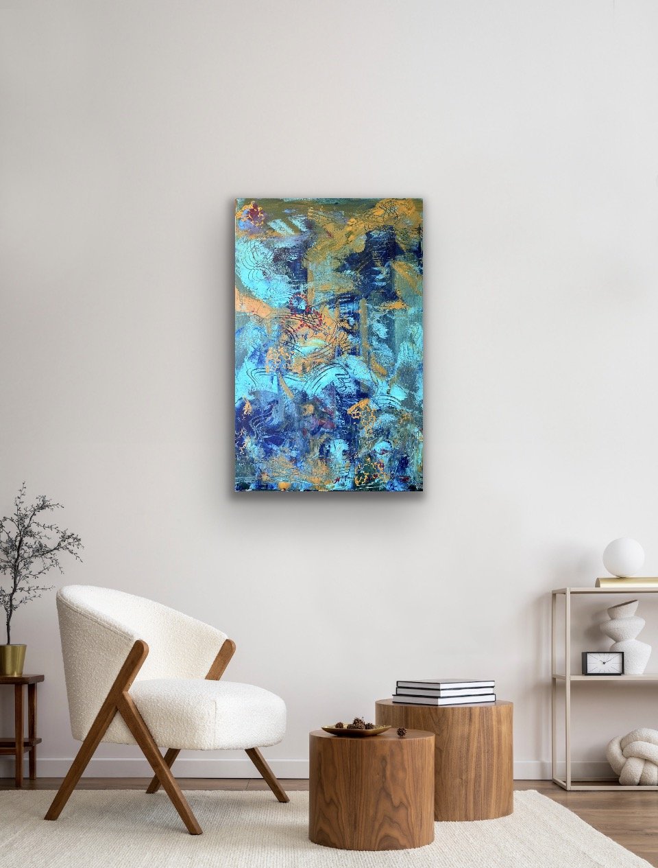 Abstract blue, gold, and teal painting hanging on a white wall in a modern living room.