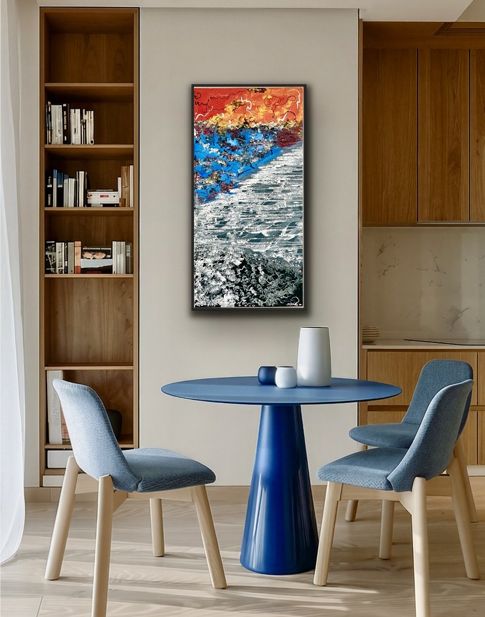 Interior of a modern dining area with a round blue table, two blue cushioned chairs, a wooden bookshelf with books, an abstract colorful painting on the wall, and decorative vases on the table.
