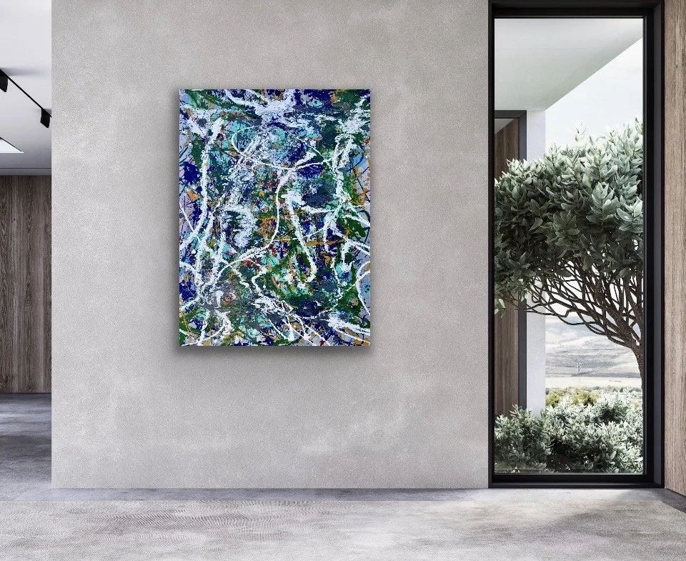 Modern interior with a colorful abstract painting on a beige wall, next to a large window showing a tree and outdoor landscape.