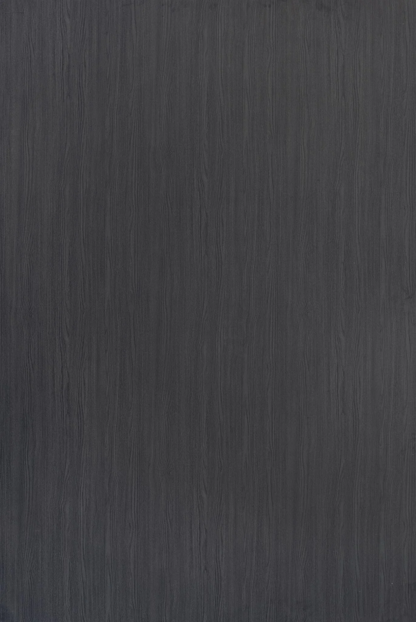 A close-up of a dark grey wooden surface with visible wood grain texture.