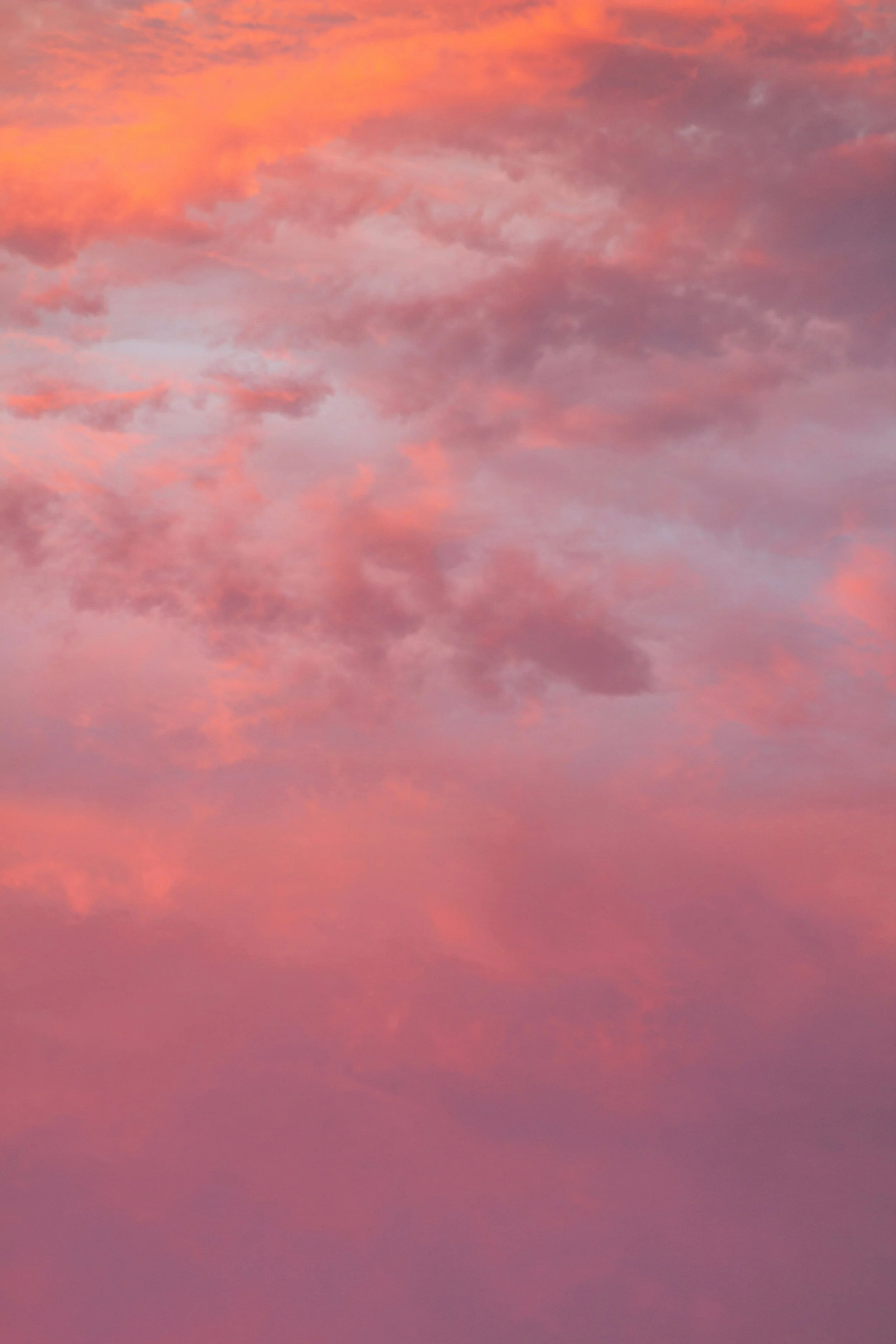 Colorful sky with pink, purple, and orange clouds during sunset or sunrise.