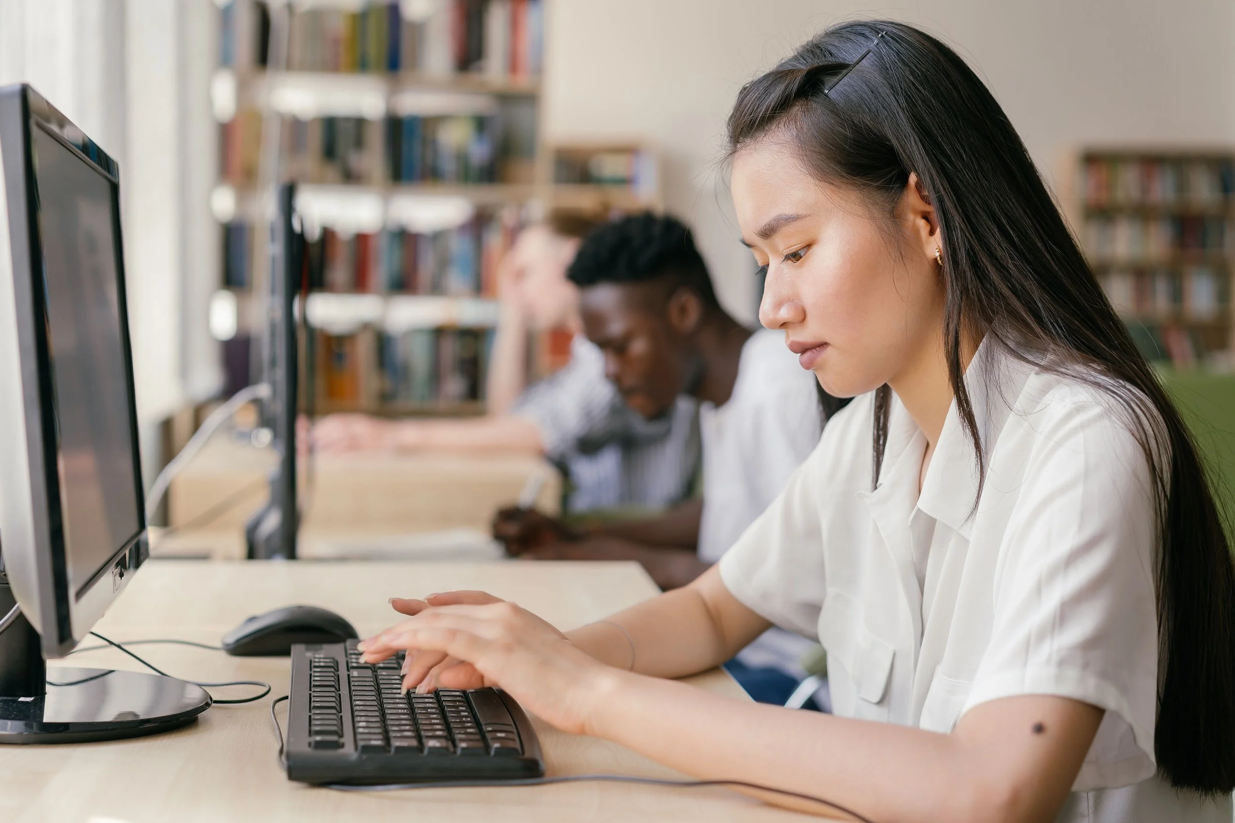 Students working on computers in a library.