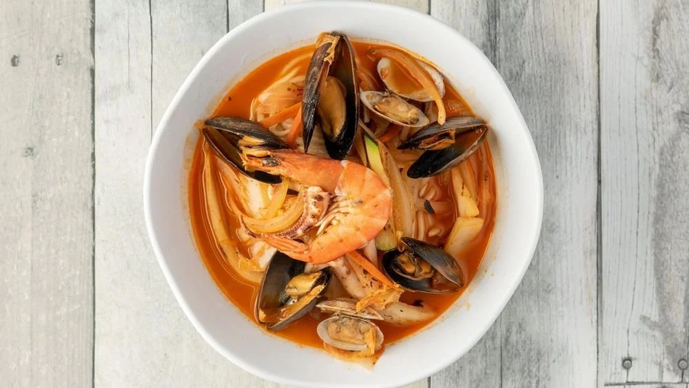 Seafood soup with mussels, shrimp, and vegetables in a spicy broth
