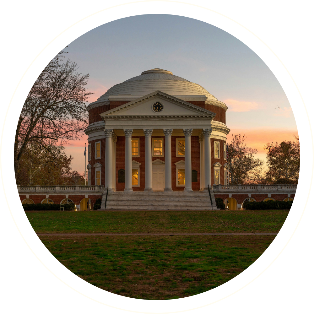 A neoclassical building with a large dome, columns, and steps leading up to it, captured during sunset with trees surrounding.