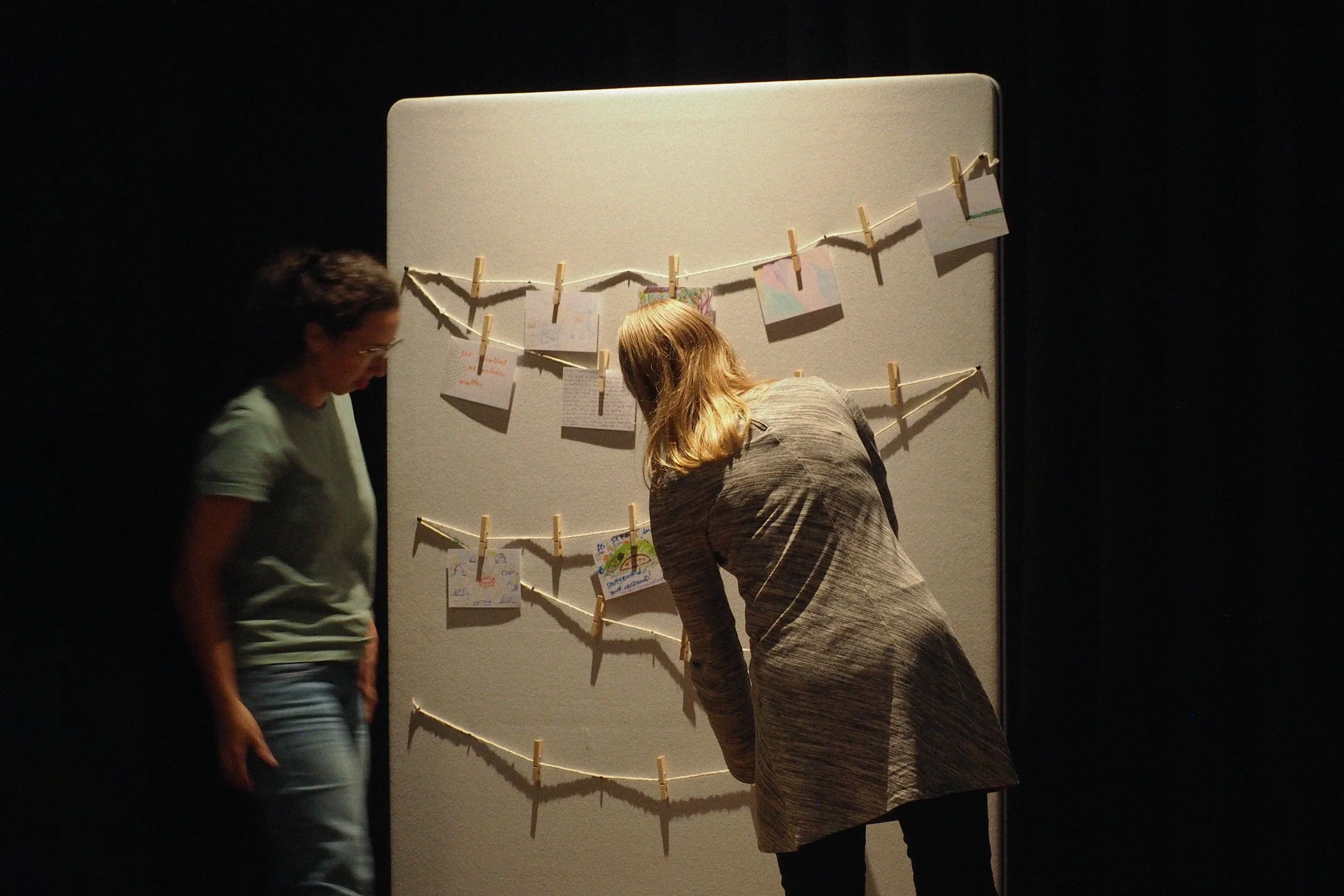 Two people mapping cards on a wall