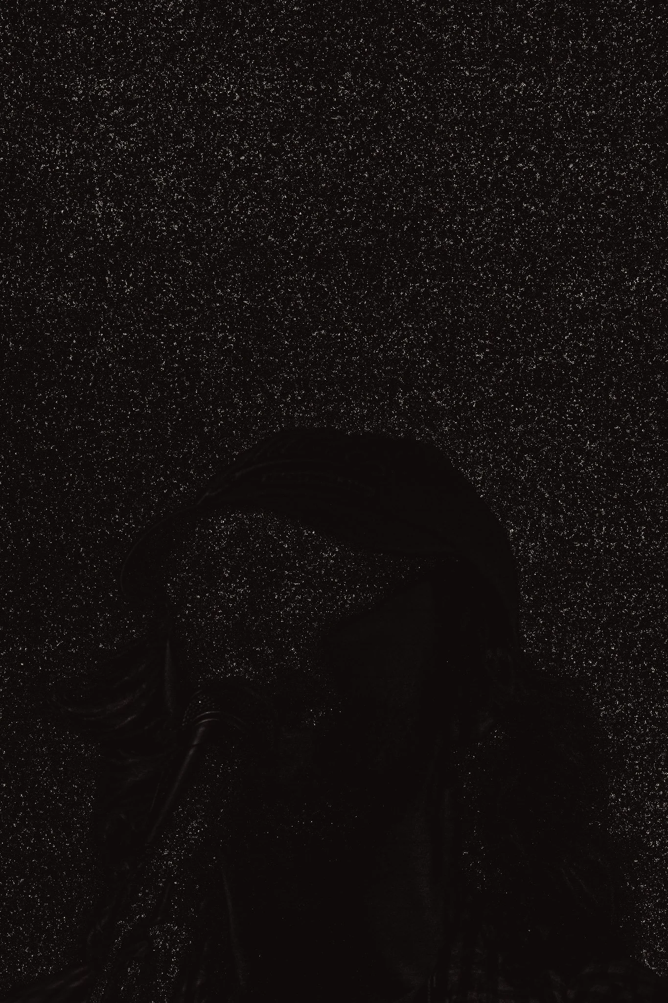 Dark floor with numerous tiny bright specks creating a starry night effect. A person's legs and shoes are visible at the bottom of the image.