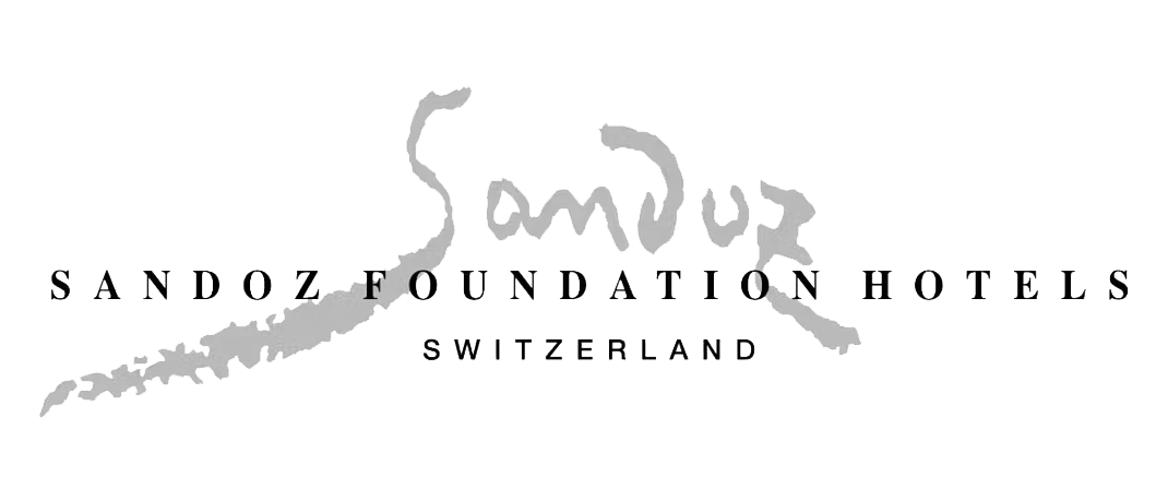 Logo of Sandoz Foundation Hotels Switzerland with stylized gray signature design.