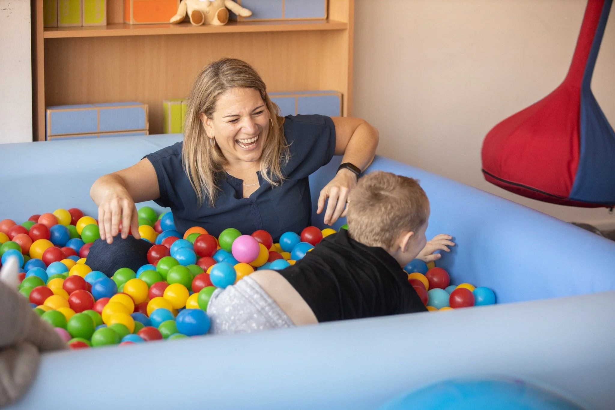 Marianela Datti in a sensory ball pool during an occupational therapy session