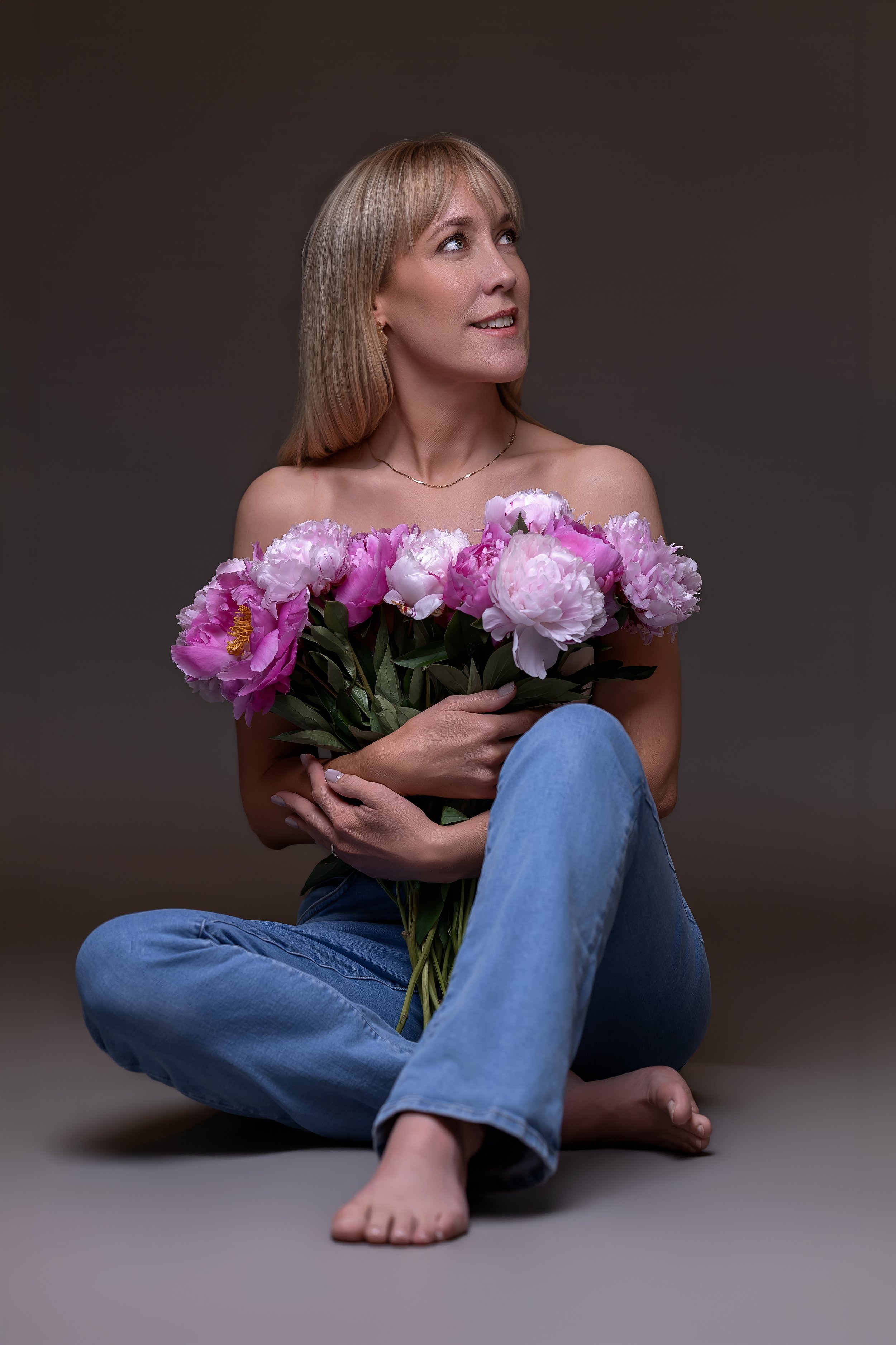 Blond kvinne sittende i skredderstilling – kvinnefotografering i studio i Oslo