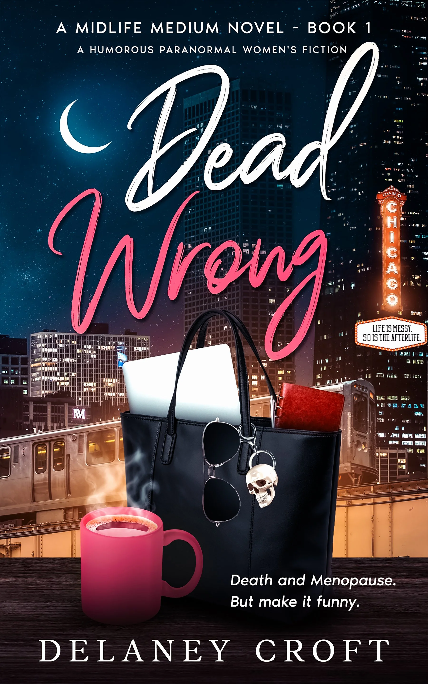 Book cover for "Dead Wrong" by Delaney Croft featuring a city skyline at night, a black tote bag with a skull keychain, notebook, a pink coffee mug, and neon signs for "Chicago" and a movie marquis sign "Life is Messy. So is the Afterlife."