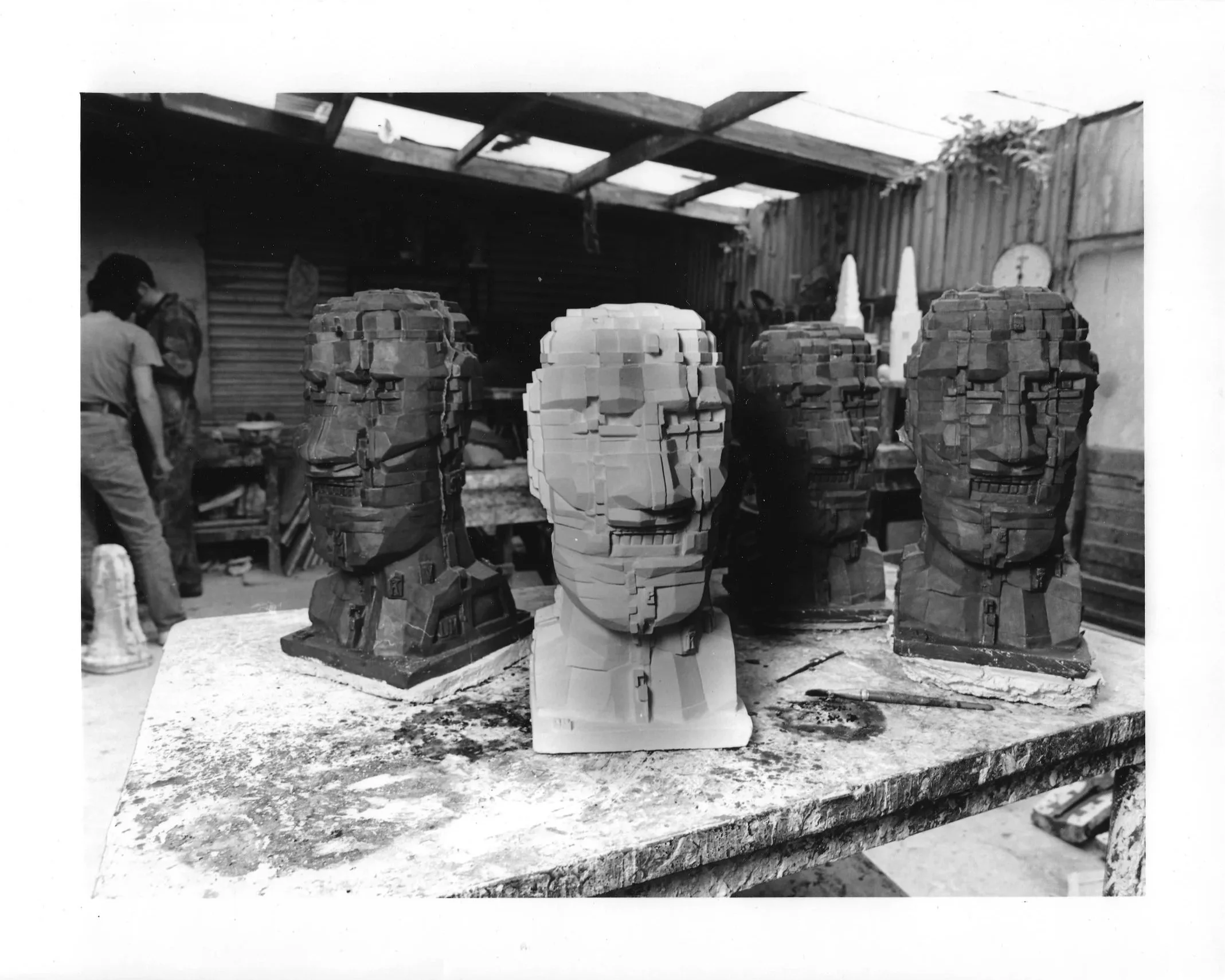 Plaster and wax versions of Eduardo Paolozzi’s Head, 1993, grouped on a workbench at Arch Bronze.