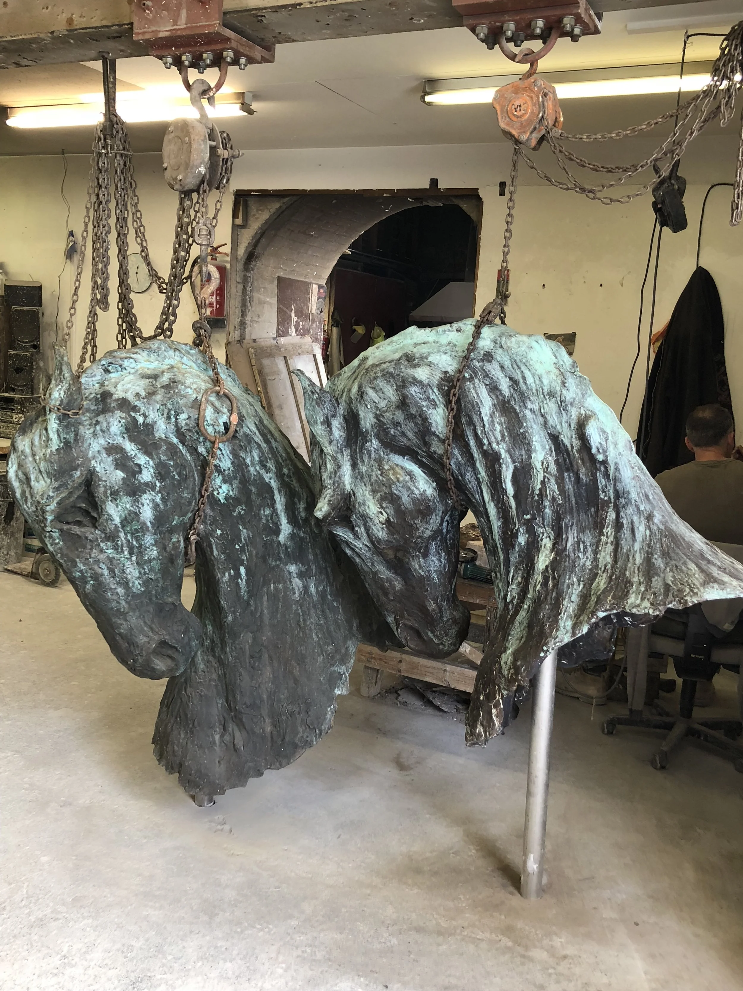 Bronze horse heads by Nic Fiddian Green during finishing at Arch Bronze.
