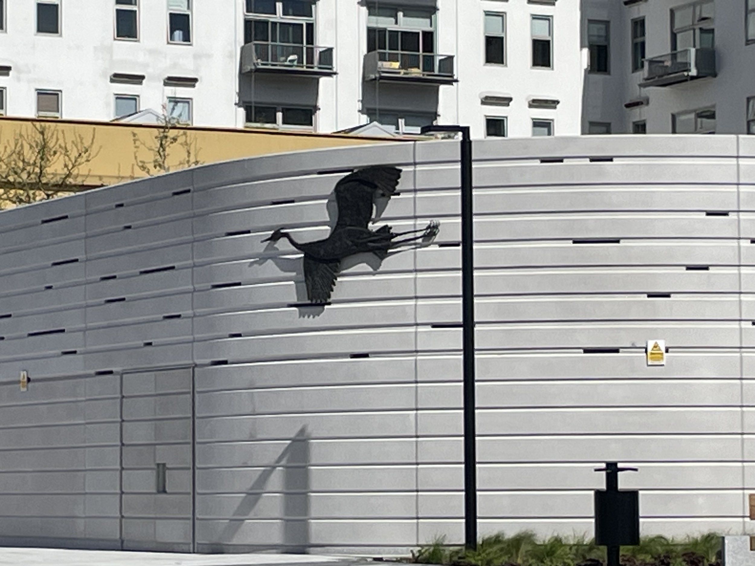 Wide view of Sarah Staton’s Heron in Flight installed at Carnwath Road Riverside, Fulham.