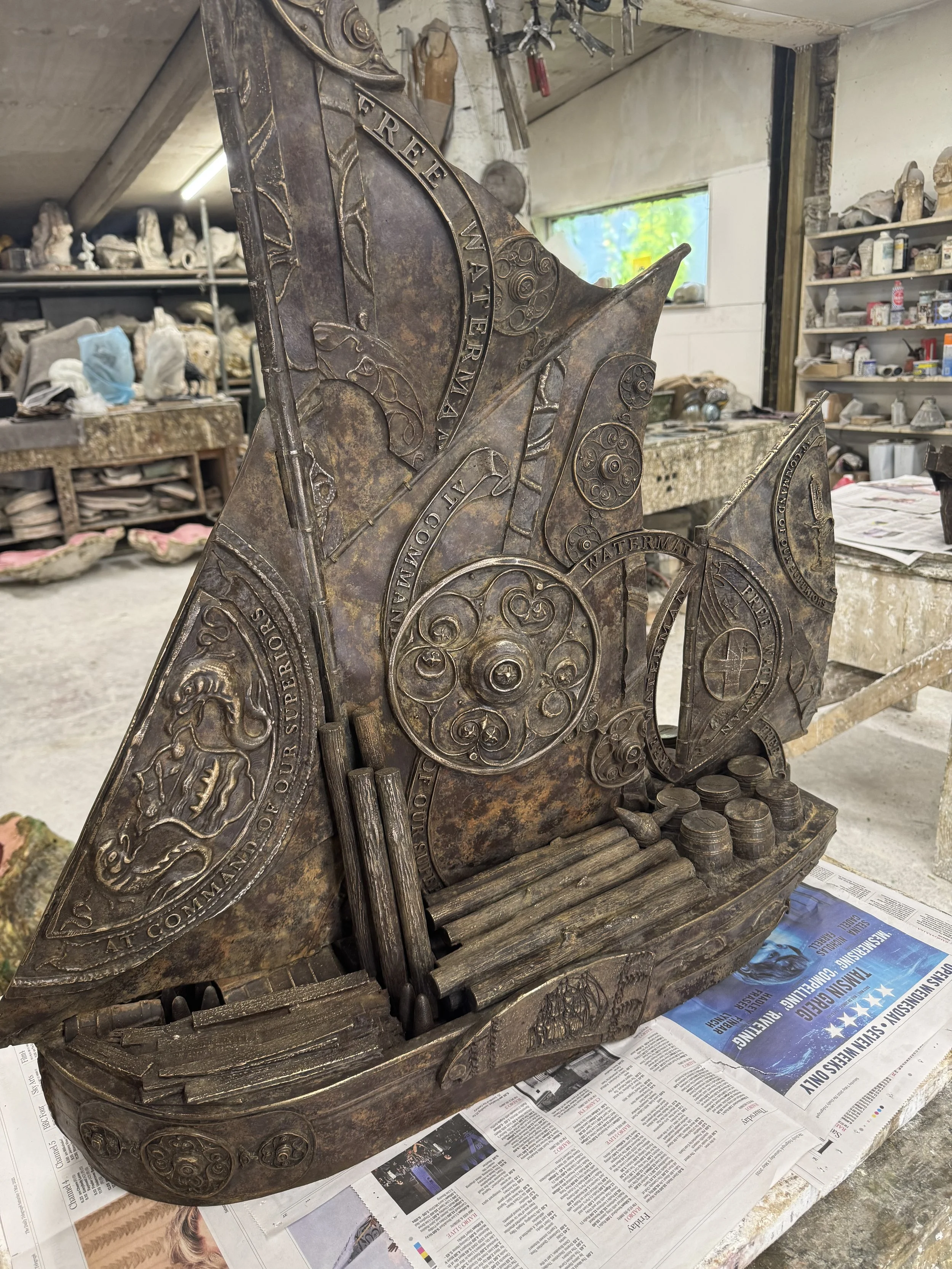 Hew Locke bronze boat sculpture from Cargoes at Arch Bronze, with decorated sails and relief details.
