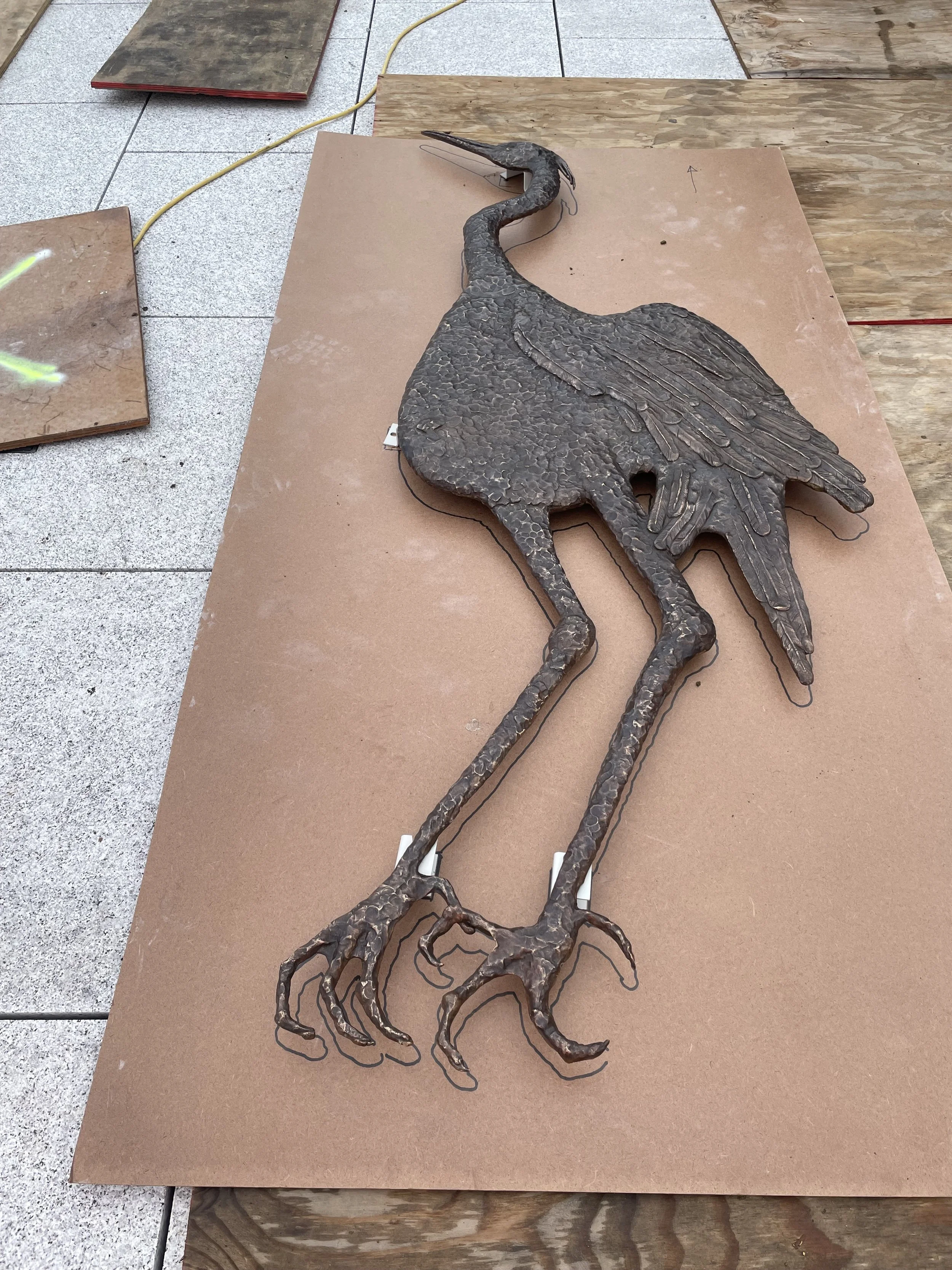 Sarah Staton’s Standing Heron bronze before installation at Carnwath Road Riverside, Fulham.