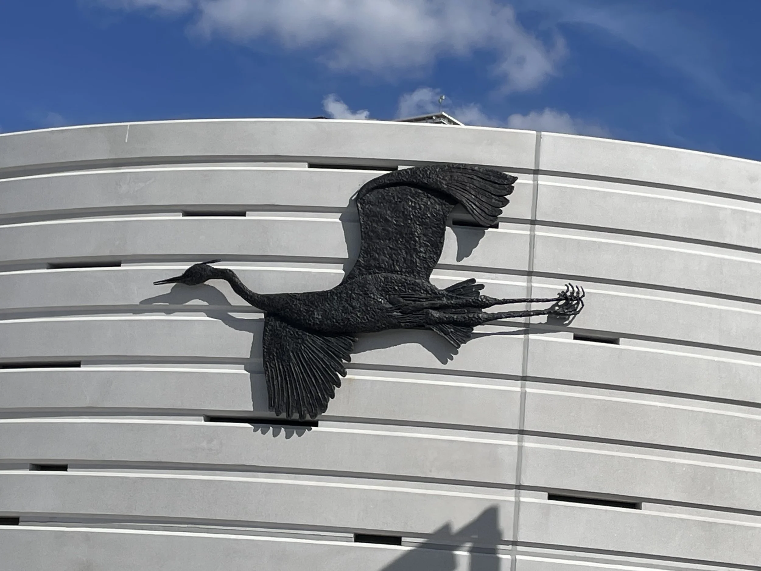 Sarah Staton’s Heron in Flight bronze installed on the wall at Carnwath Road Riverside, Fulham.
