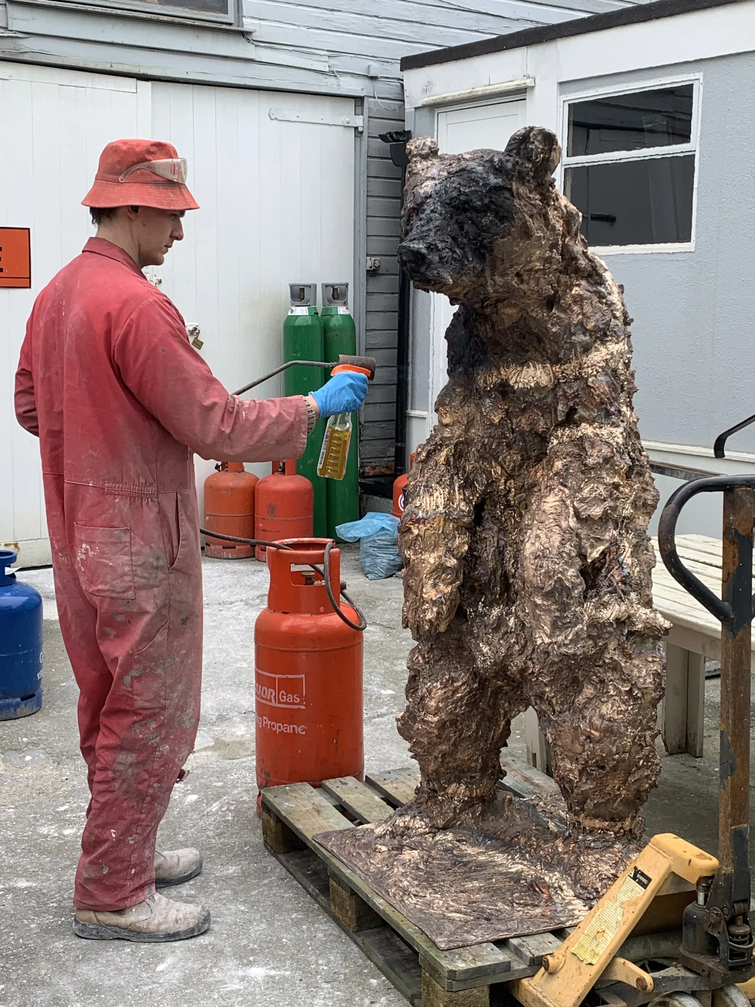 Patination being applied to a large bronze sculpture at Arch Bronze.