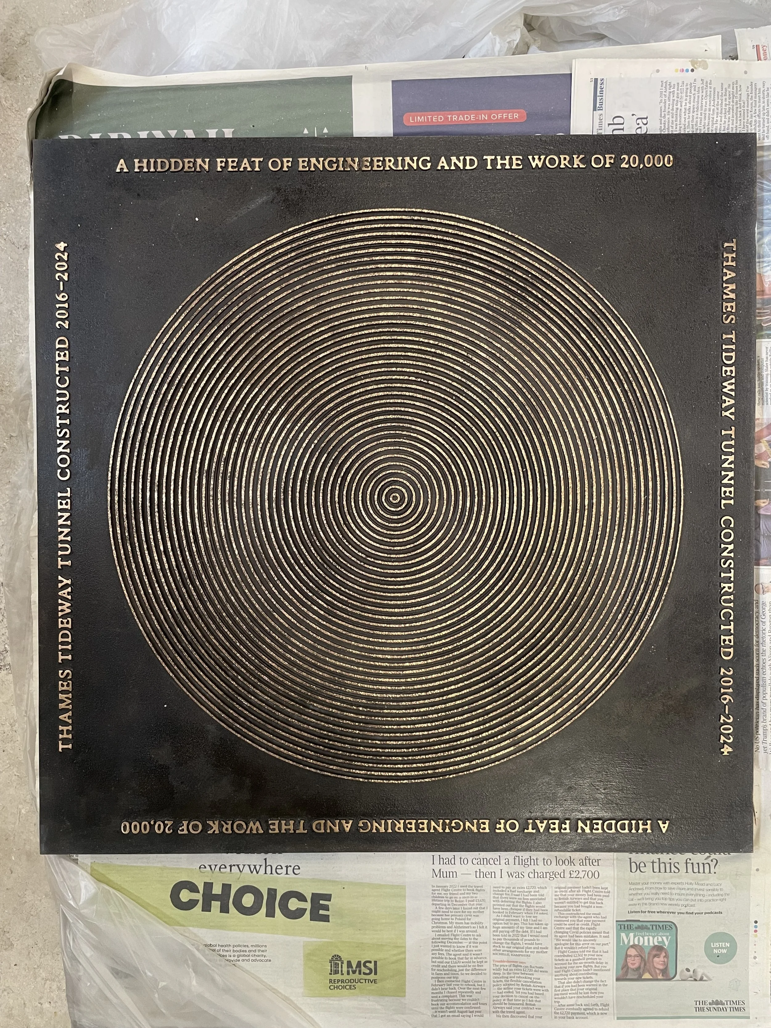 Concentric-circle Tideway bronze street cover designed by Marina Willer of Pentagram, finished at Arch Bronze.