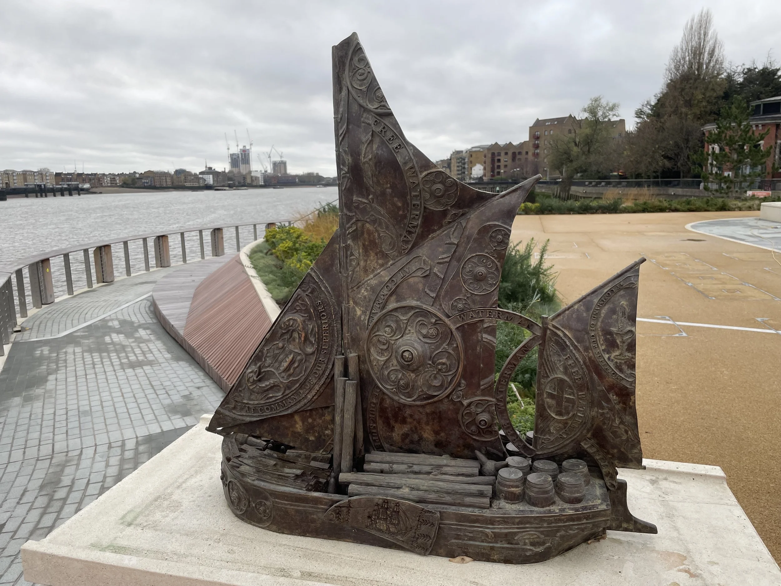 Close view of a Hew Locke Cargoes bronze boat installed beside the Thames at King Edward Memorial Park.