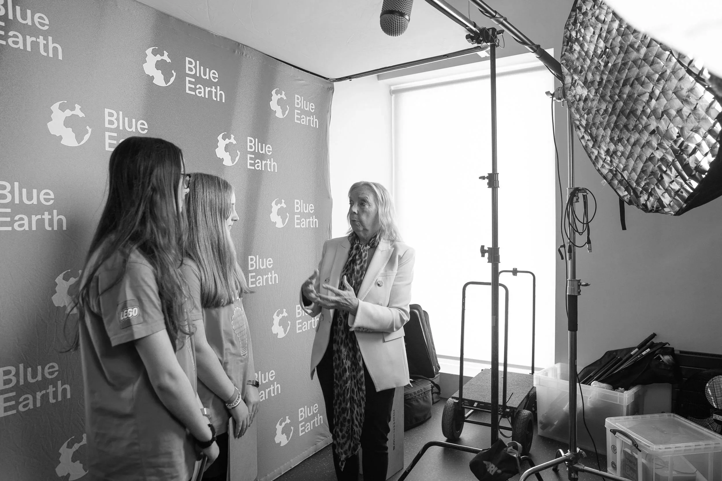 Image of two LEGO Build the Change Youth Council participants interview entrepreneur Deborah Meaden in the press room at The Blue Earth Summit.