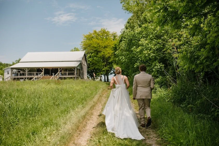 Barrien Springs Wedding Planner Bride and Groom Walking Up To Reception Space at Wedding
