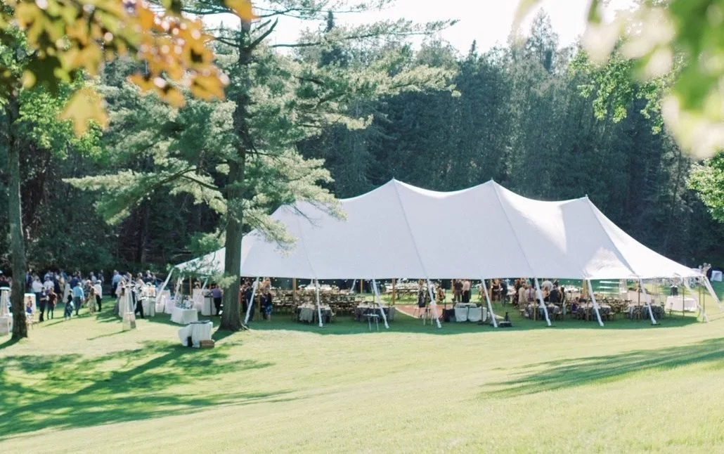 Beautiful Tented Landscape wedding reception during cocktail hour