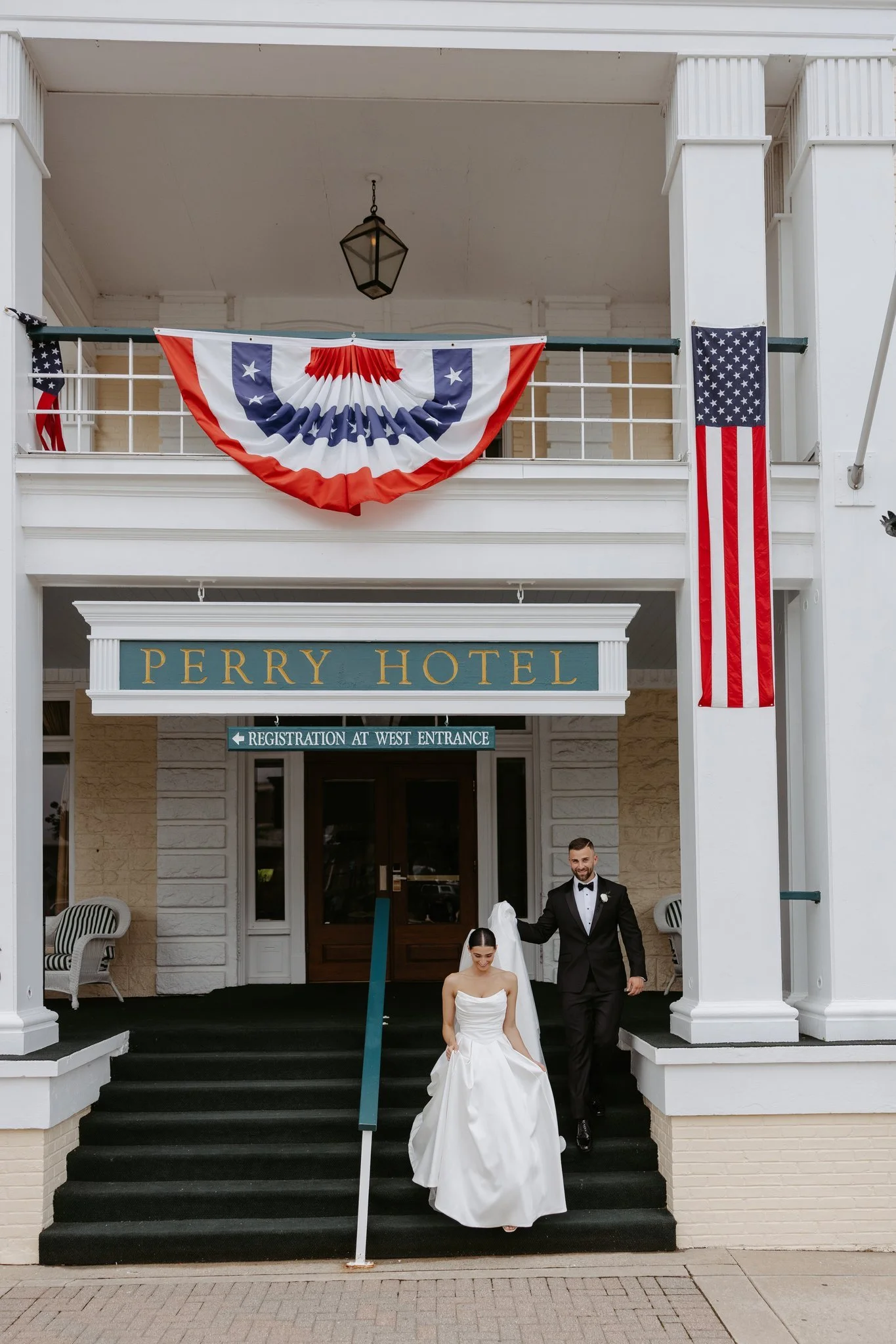 Hannah and Atticus walking down the Perry Hotel’s front steps in Petoskey, Michigan. Photography by Amelie Ferdais.