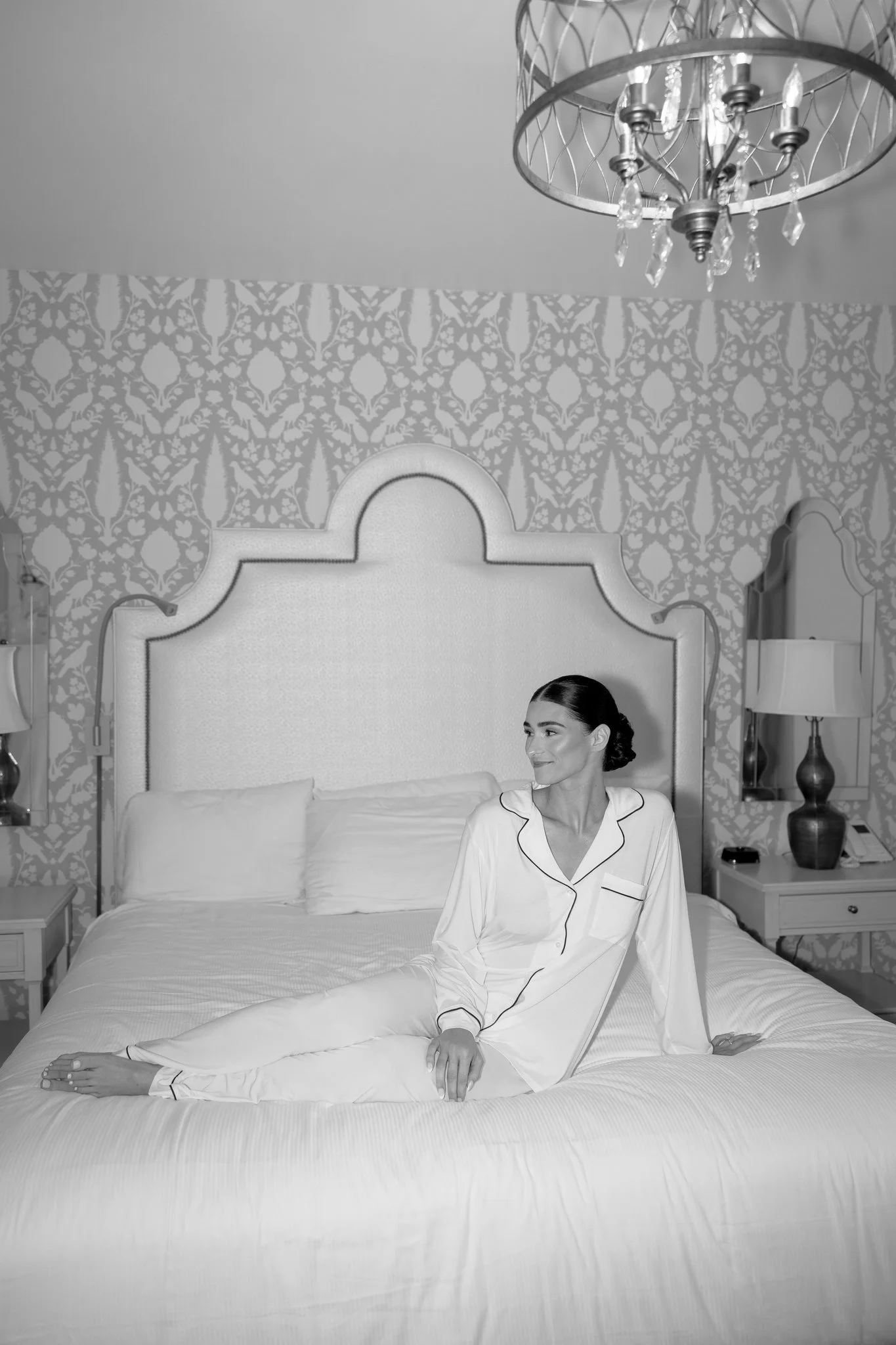 Black-and-white portrait of Hannah in pajamas before her Petoskey wedding. Photography by Amelie Ferdais.
