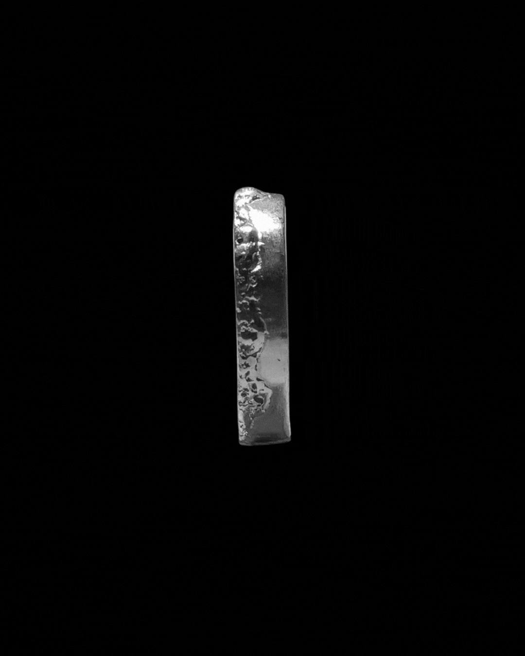 A shiny, metallic number one against a black background.