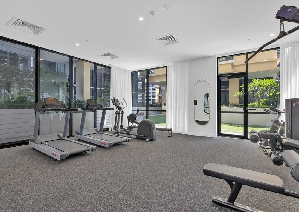 Apartment residents’ gym with treadmills, an exercise bike and strength-training equipment.