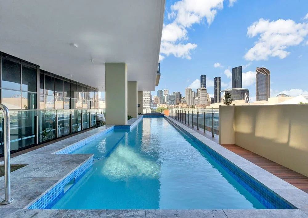Apartment lap pool overlooking the city skyline.