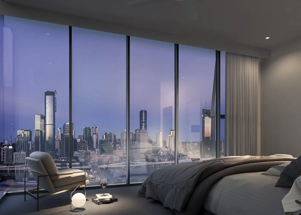 Apartment bedroom with floor-to-ceiling windows overlooking the city skyline at dusk.