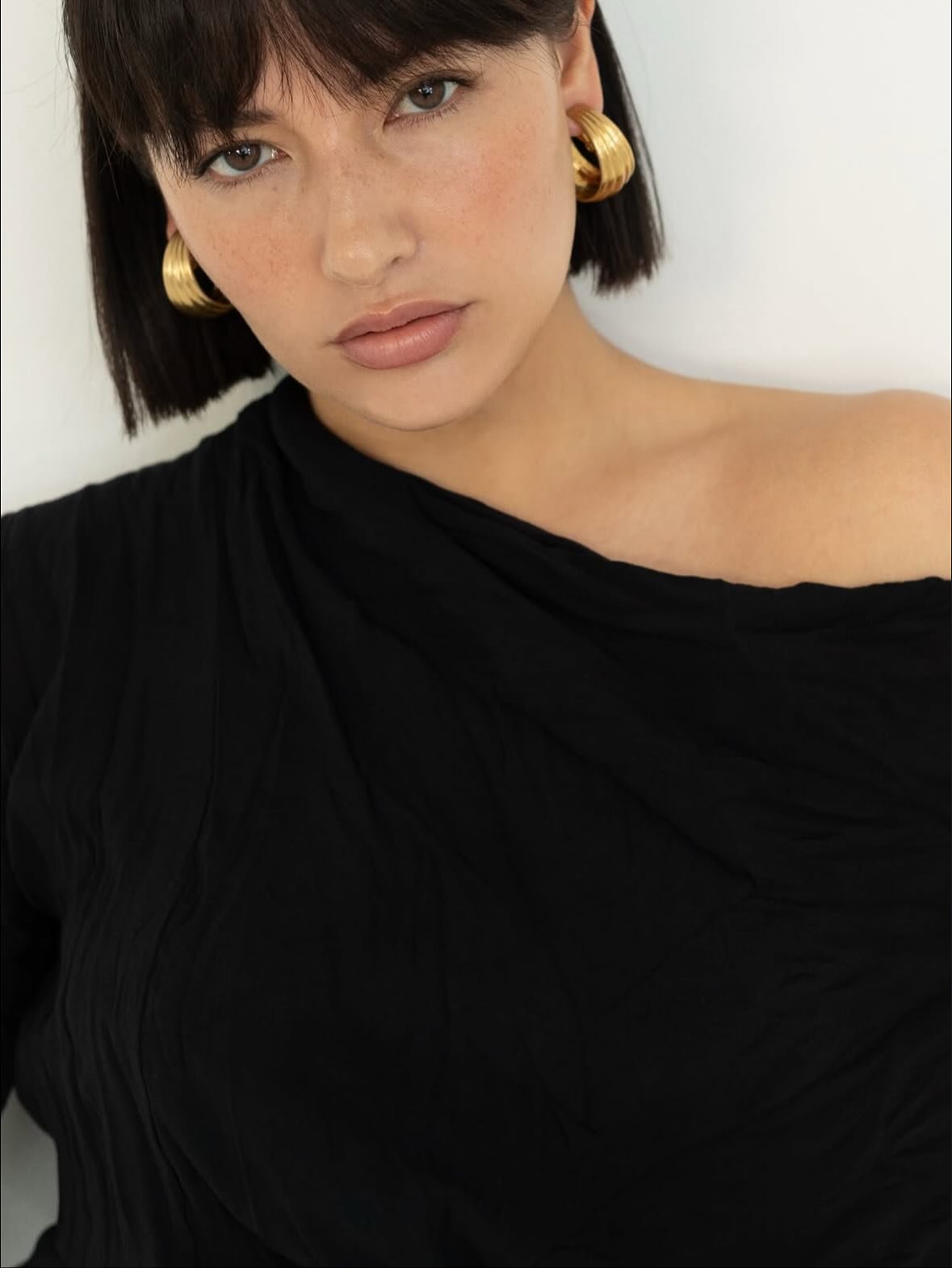 Sleek dark bob with a full fringe, shared by Alkemi Salon in Mount Pleasant.