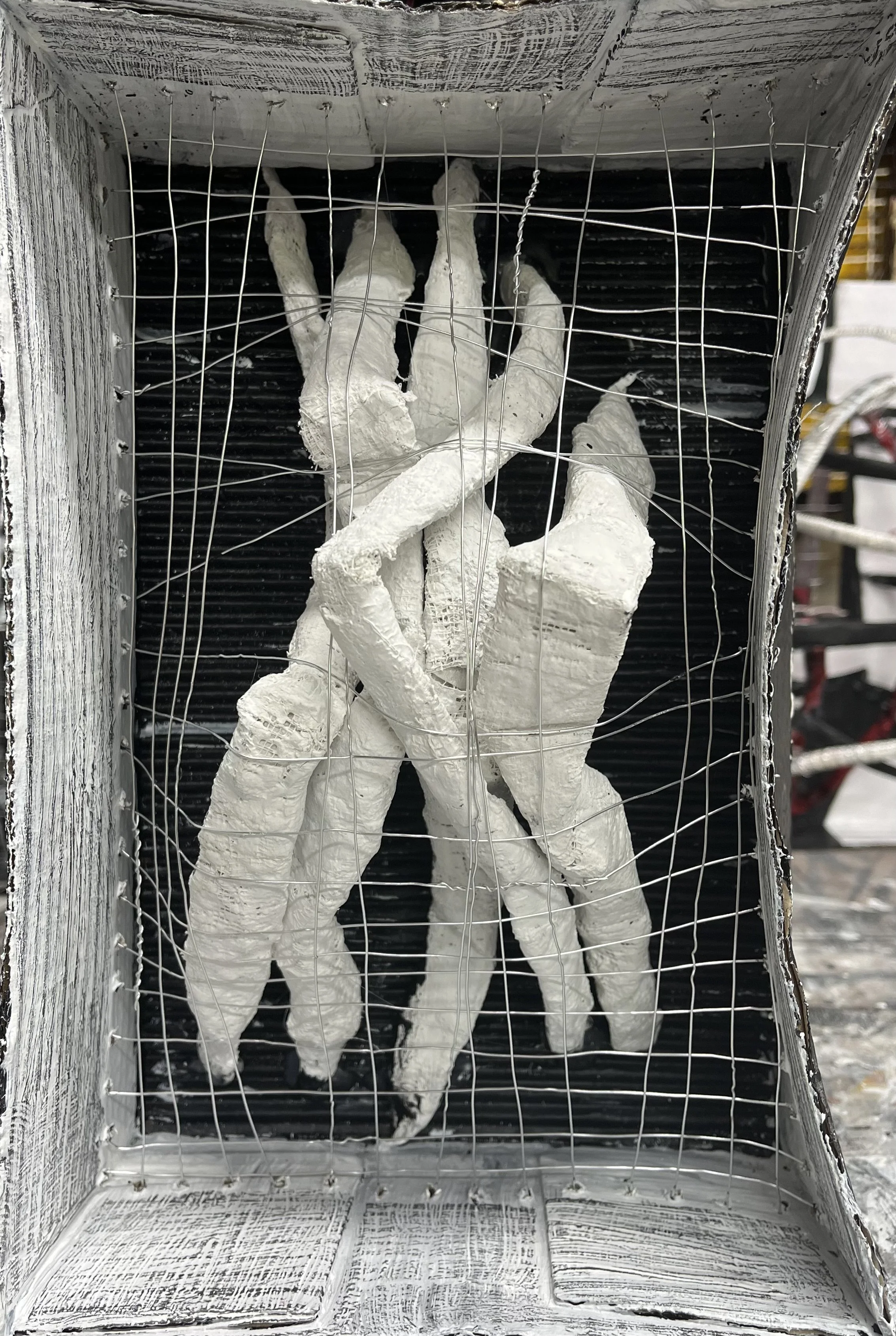 Bent - 7.5" x 11" x 4". Cardboard box, wire, Plaster of Paris, newspaper, acrylic paint, and pencil. 