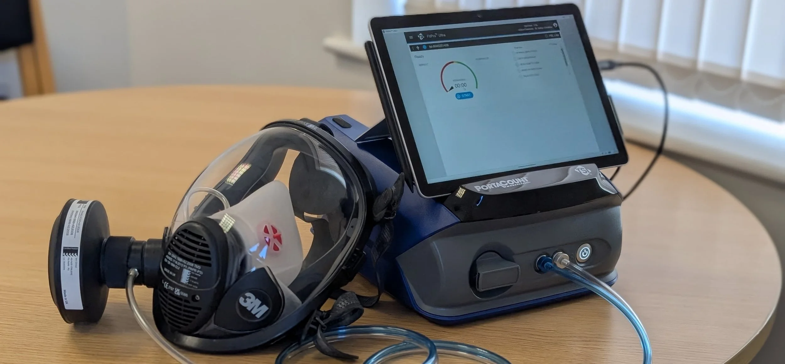 full face Respiratory Protective Equipment (RPE) mask connected to a  portacount face fit test machine