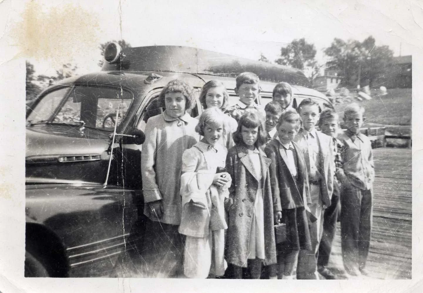 “Junk it” school bus, first day of school. Front row, left to right: Edith Jones Larson, unidentified, Roberta Gomez Ricker, Albion Morton, Gordon Stewart, Robert Ridgewell; back row, left to right: Doris Ricker Wood, Janet Doughty Rich, Tommy Pissak