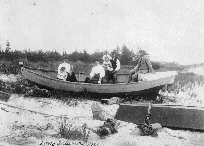 Dory on South Beach, ca. 1909: Jeanne Marchand, unknown woman, Beatrice Marchand, Paul Marchand Sr., Donat Marchand, and unknown man. Gift of Linda Marchand. 1998.86.6