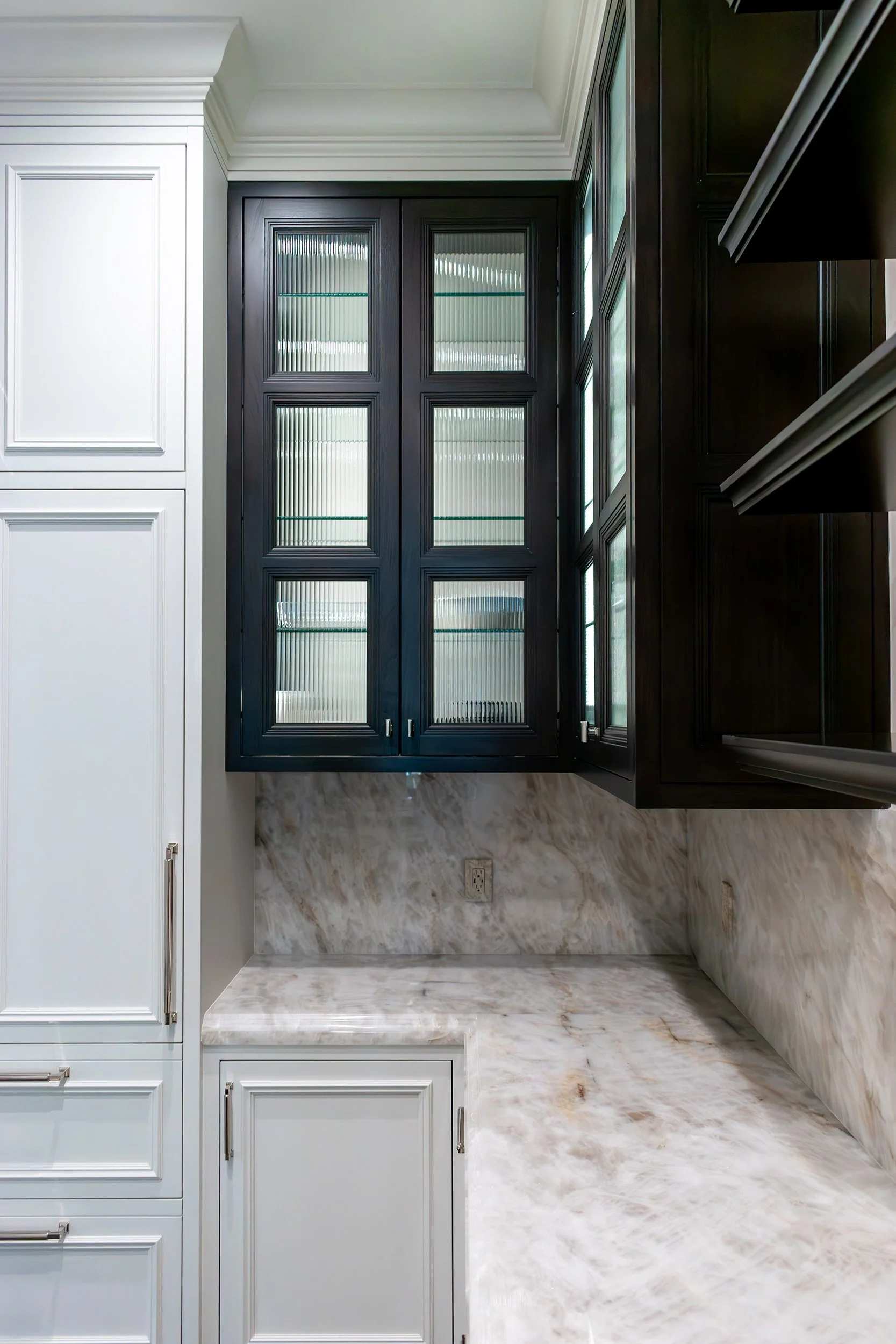 Dark-stained cabinets with reeded glass