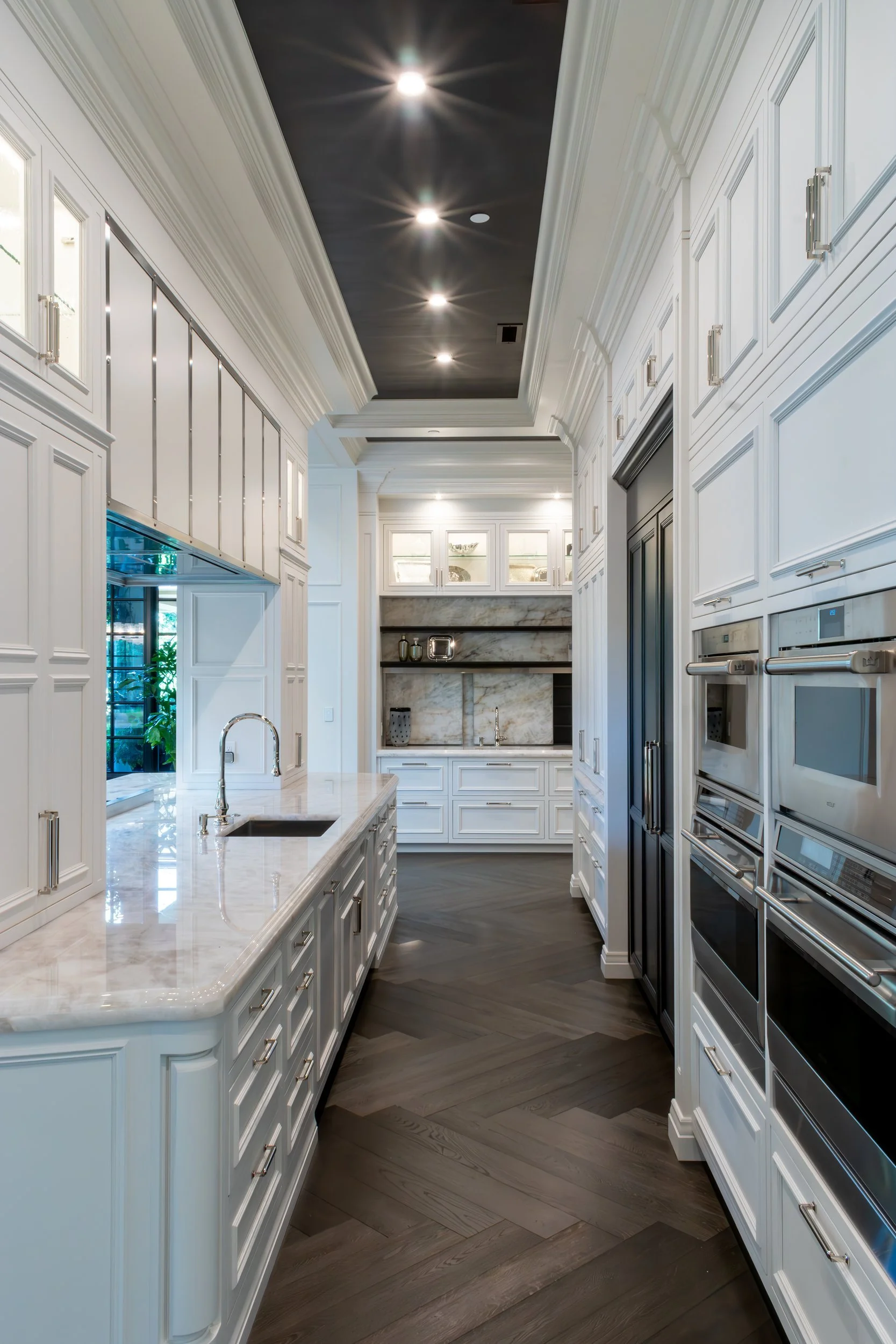 Prep galley with wall ovens and a second sink