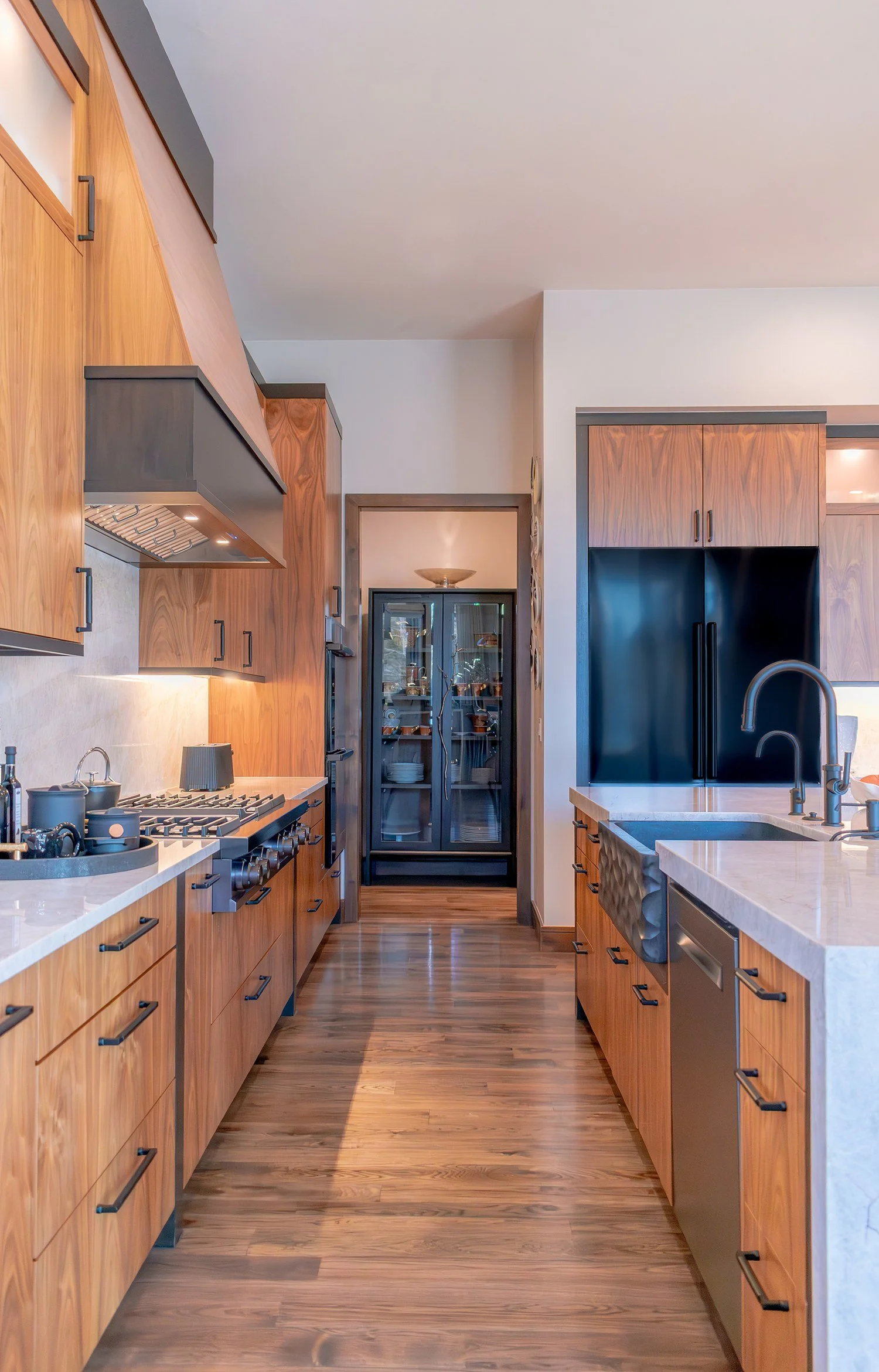 Galley kitchen in warm wood cabinetry