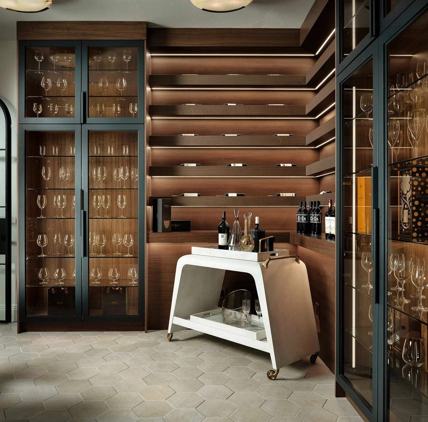 Wine room with lit shelves and glass-front cabinets