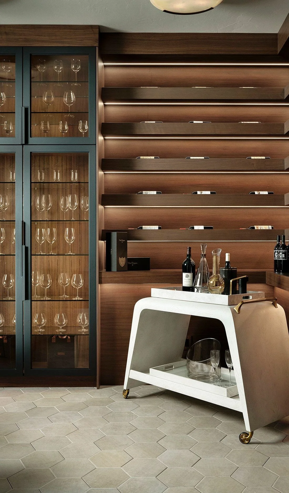 Wine room with glass-front cabinets, lit walnut shelves and a bar cart