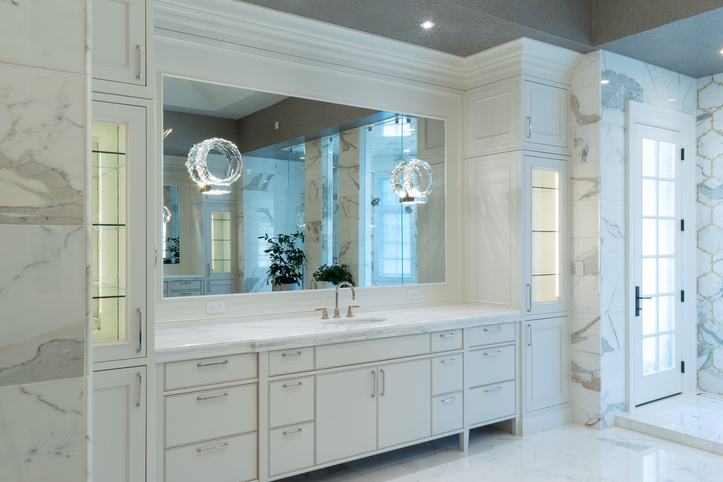 Painted bath vanity with marble top and brass faucet