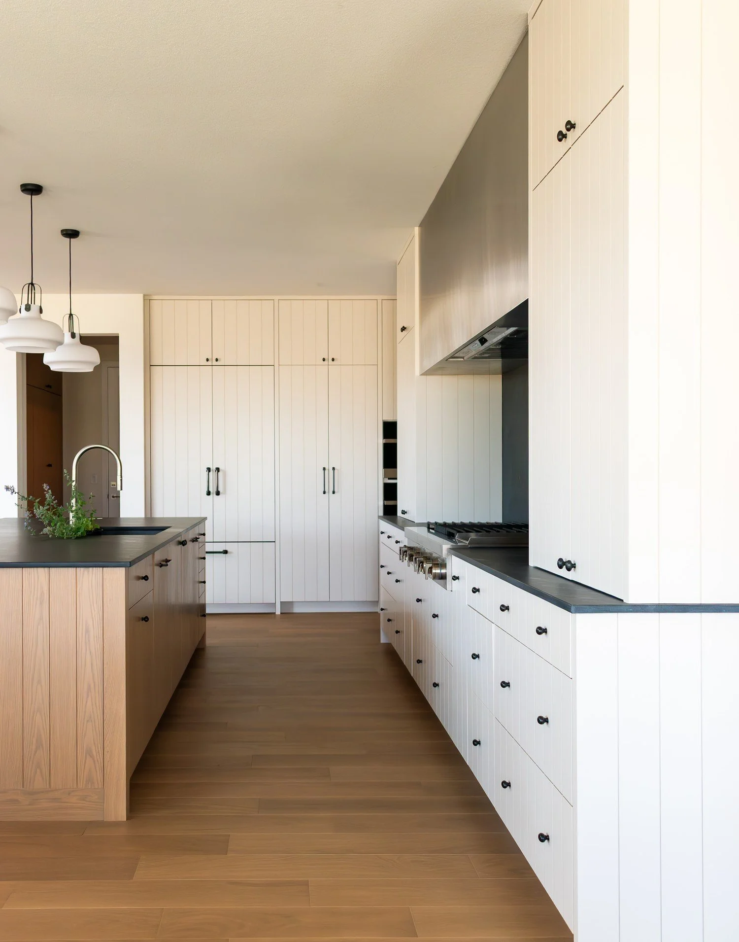 The White Oak Kitchen: aisle between the oak island and the range wall